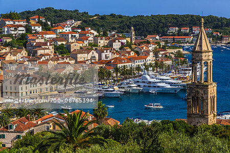 Yachts in the marina at the Old Town of Hvar with St Mark's Church bell tower (right) on Hvar Island, Croatia