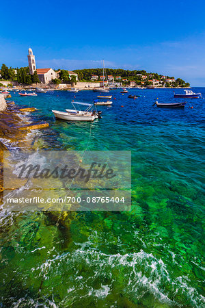 Boats anchored in harbour with the Franciscan Monastery in the background in the Old Twon of Hvar on Hvar Island, Croatia