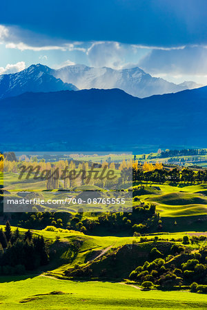 Rain clouds over the mountains and the fertile, Wakatipu Basin near Queenstown in the Otago Region of New Zealand Rain clouds over the mountains and the fertile, Wakatipu Basin near Queenstown in the Otago Region of New Zealand
