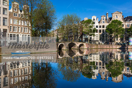 Stone bridge crossing the Herengracht on a sunny day in Amsterdam, Holland