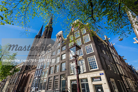 Top section of a tradtional building next to the De Krijtberg Church along Singel in Amsterdam, Holland