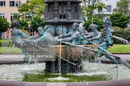 Sculpture of rowers at the base of the column of the Koblenz Historical Fountain in Josef Gorres Platz in Koblenz, Germany