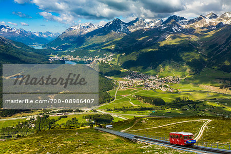 Overview of the Engadin valley with the funicular railway from Punt Muragl up to the Muottas Muragl, near St Moritz, Switzerland.