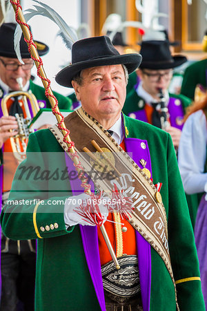 Close-up of man and musicians in Austrian traditional dress at the Feast of Corpus Christi Procession in Seefeld, Austria