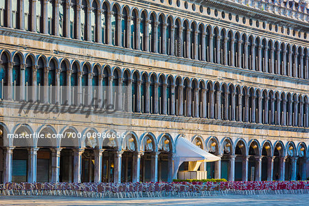 Cafe entrance and patio with empty seats on St Mark's Square at sunrise in Venice, Italy Cafe entrance and patio with empty seats on St Mark's Square at sunrise in Venice, Italy