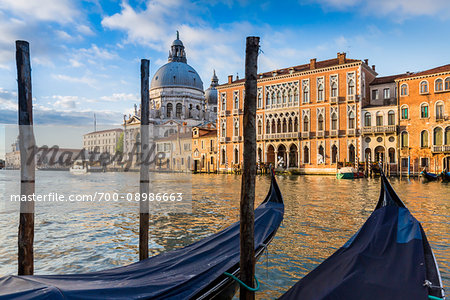 Gondola moored at a station along the Grand Canal with the dome of Santa Maria della Salute in the background in Venice, Italy Gondola moored at a station along the Grand Canal with the dome of Santa Maria della Salute in the background in Venice, Italy