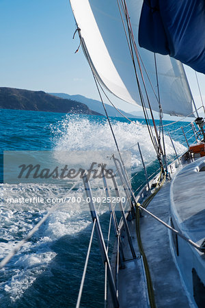 Waves splashing against sailboat while sailing around the Whitsunday Islands in Queensland, Australia