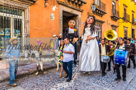 Mexican wedding procession through the streets of San Miguel de Allende with papier-mache bride and groom and Mariachi band in Guanajuato State, Mexico