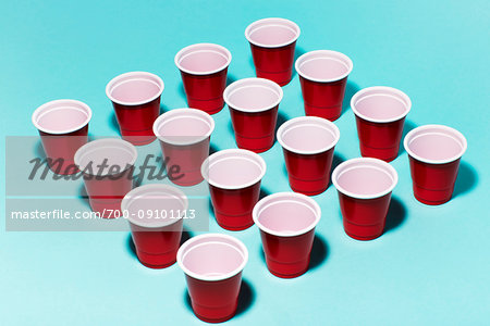 Red solo cup, plastic party cups in rows forming a square on a turquoise background