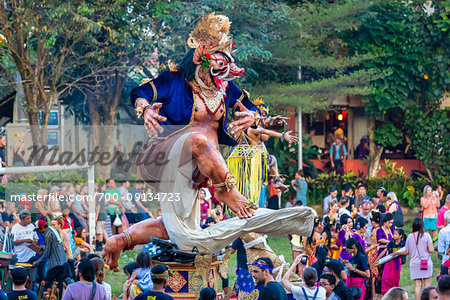 Crowds and procession of Ogoh-ogoh statues in the Ngrupuk Parade on the eve of Nyepi Day in Ubud in Gianyar, Bali, Indonesia