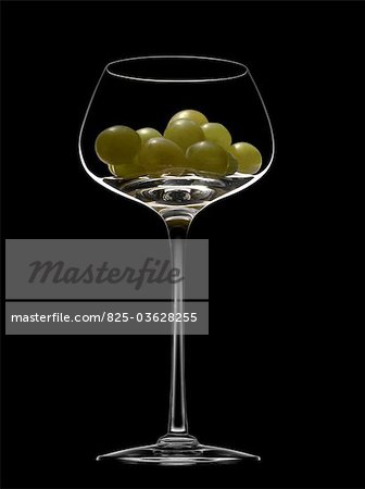 White grapes in a wine tasting glass