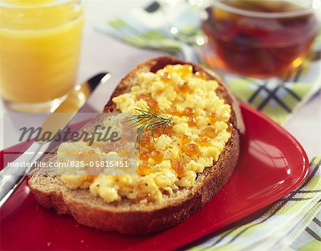 Scrambled eggs with Emmental and salmon roe on a slice of bread