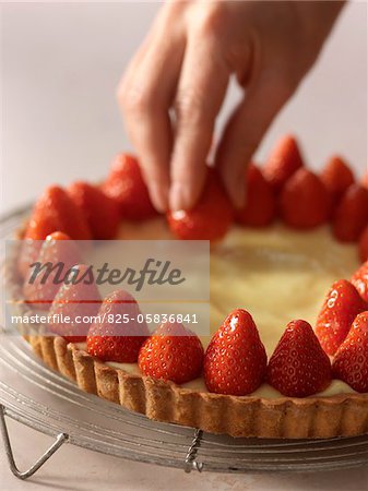 Placing the strawberries on the pastry and custard