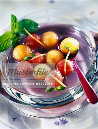 dish of watermelon and melon in violet syrup