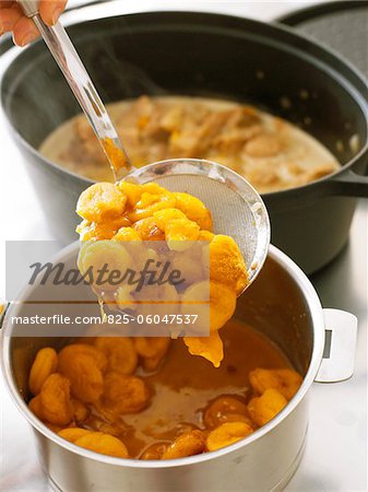 Cooked carrots and apricots in a cooking pot