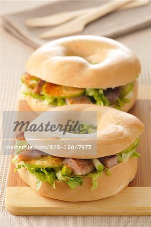 Raw vegetable and herring bagel sandwich