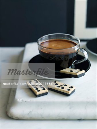 Cup of expresso and dominos