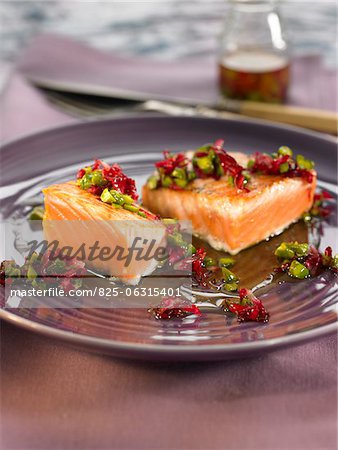 Thick pieces of salmon with pistachios and rose petals