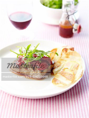 Grilled beef steak with stewed red peppers and crisps