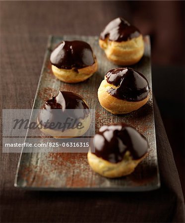 Choux buns coated in melted chocolate Choux buns coated in melted chocolate