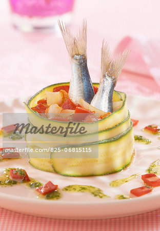 Zucchini roll garnished with red peppers and sardines