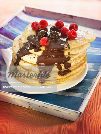 Pancakes with melted chocolate and raspberries