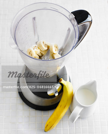 Preparing a banana milkshake in a blender