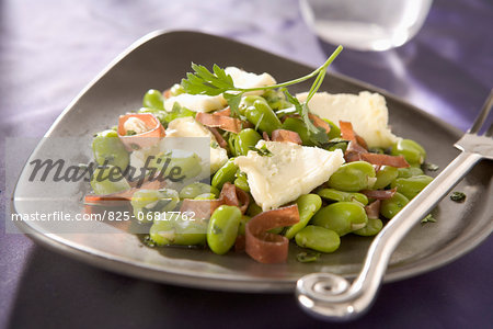 Pan-fried fava beans with raw ham and Chaource