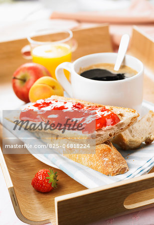 Continental breakfast on a tray :coffee,bread and jam,orange juice