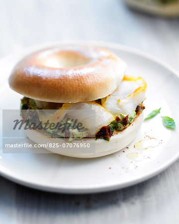 Avocado,cottage cheese and smoked fish bagel sandwich