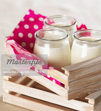 Glass pots of plain yoghurt