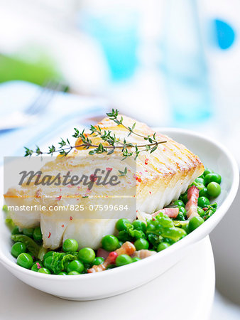 Piece of cod with thyme and pink peppercorns,peas with diced bacon