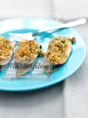 Sardines stuffed with pine nuts,bread crumbs and raisins,bay leaves and orange sauce