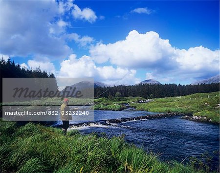 Side profile of a man fly-fishing in a river, Connemara, County Galway, Republic Of Ireland