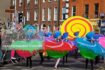 Dublin, Ireland; Women Dancing In Costumes As Part Of A Parade On O'connell Street