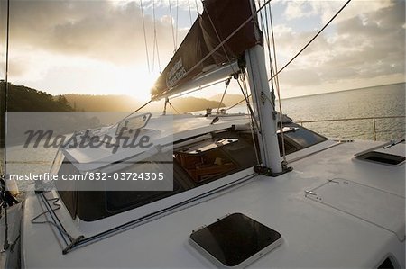 Sailboat at sunset off Whitsunday Islands