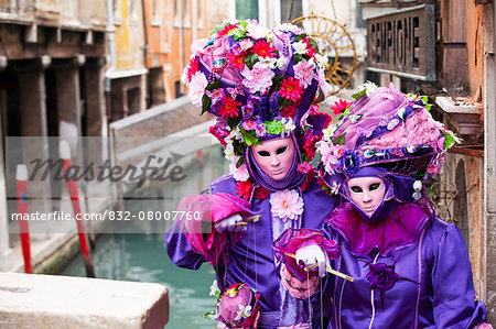 Lady and gentleman in red and white masks, Venice Carnival