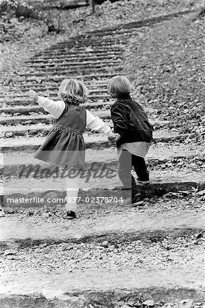 Rear View Of A Boy With His Sister Moving Up On Steps Stock Photo Masterfile Rights Managed Artist Glowimages Code 7