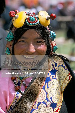 Young woman wearing typical amber jewellery, Yushu Horse Fair, Qinghai Province, China, Asia