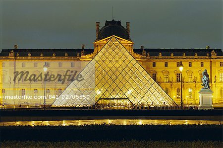 The Louvre and pyramid illuminated at night, Paris, France, Europe