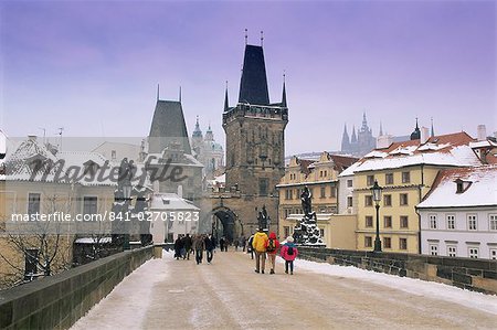 Charles Bridge and St. Vitus cathedral in winter snow, Prague, UNESCO World Heritage Site, Czech Republic, Europe Charles Bridge and St. Vitus cathedral in winter snow, Prague, UNESCO World Heritage Site, Czech Republic, Europe
