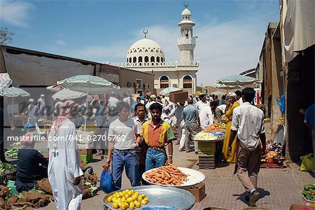 Vegetable souk with mosque behind, Abu Dhabi, United Arab Emirates, Middle East