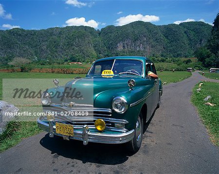 A green Plymouth taxi, a classic pre-Castro American car, in Two Sisters Valley, Vinales, Cuba, West Indies, Caribbean, Central America