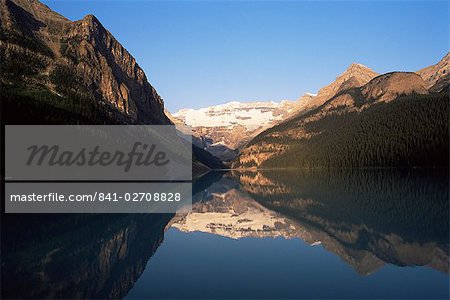 View to Mount Victoria across the still waters of Lake Louise, at sunrise in summer, Banff National Park, UNESCO World Heritage Site, Alberta, Canada, North America