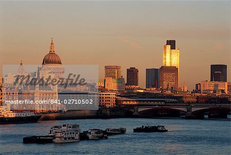 City skyline, including St. Paul's Cathedral, the NatWest Tower and Southwark Bridge, from across the Thames at dusk, London, England, United Kingdom, Europe