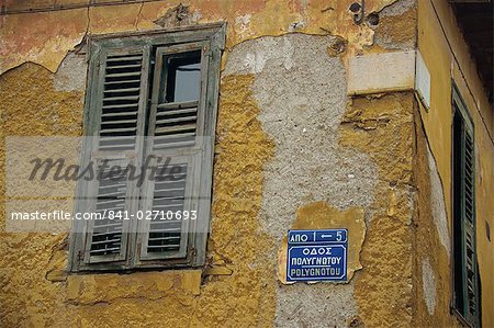 Street sign and shutters on an old building in the Plaka area of Athens, Greece, Europe