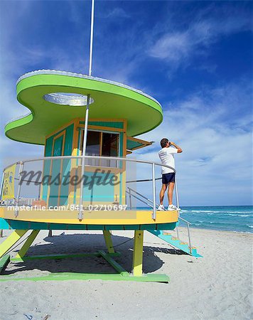 Lifeguards hut with man looking out to sea with binoculars, South Beach, Miami, Florida, United States of America, North America