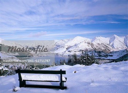 Bench at Bealach Ratagain viewpoint looking towrds the head of Loch Duich in Glen Sheil after a heavy snow fall, Ratagain Pass, Highland region, Scotland, United Kingdom, Europe
