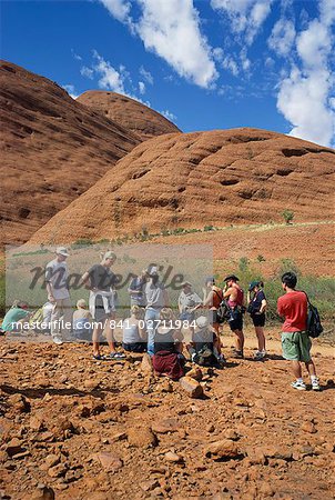 A group of tourists trekking in the Valley of the Winds in the Olgas, in Northern Territory, Australia, Pacific
