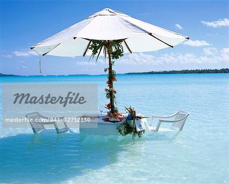 White table, chairs and parasol in the ocean, Bora Bora (Borabora), Tahiti, Society Islands, French Polynesia, South Pacific Islands, Pacific